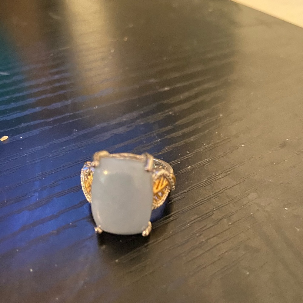 Ring with large light blue stone
